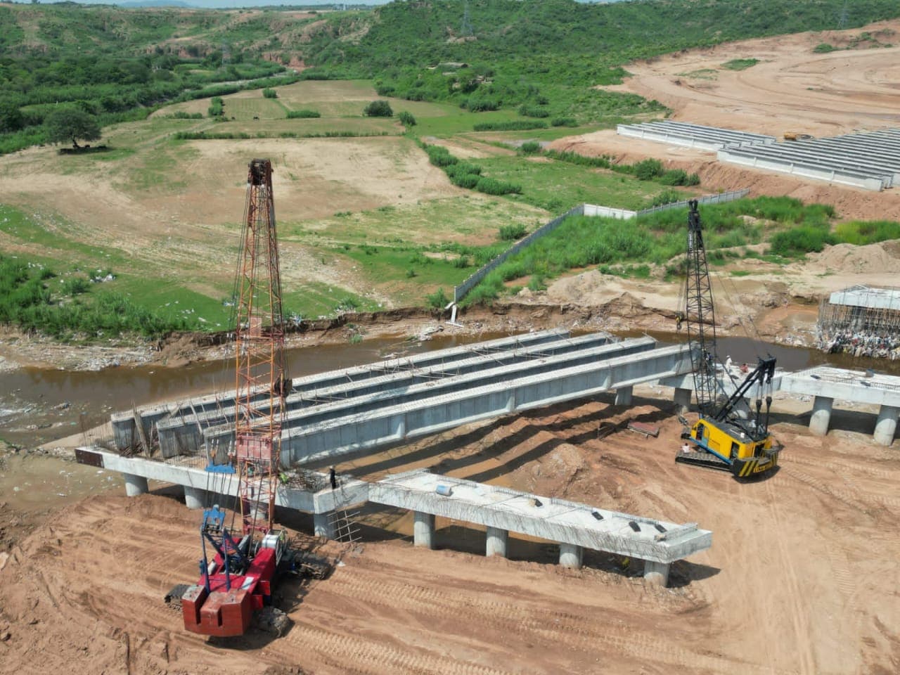 Cranes lifting bridge girders at a construction site